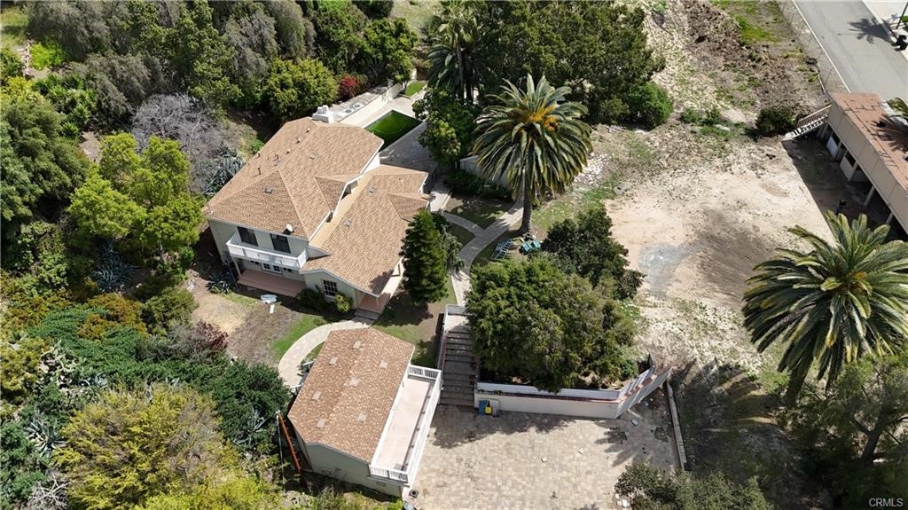 an aerial view of a house with garden space and sitting area