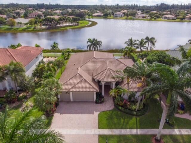 an aerial view of a house with outdoor space and lake view