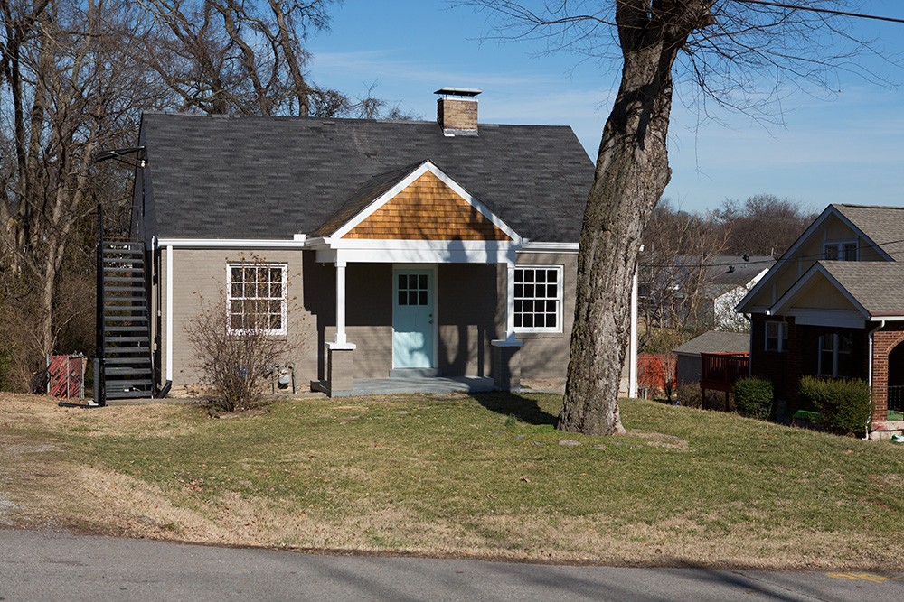 a front view of a house with garden