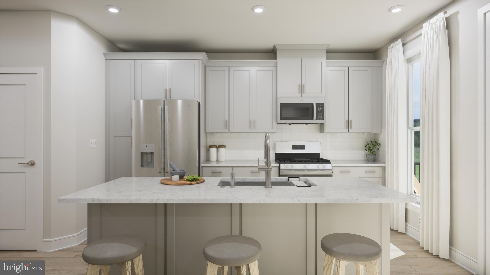 a kitchen with stainless steel appliances a sink and cabinets