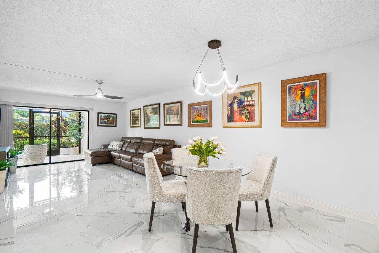 a dining room with furniture a potted plant and a rug