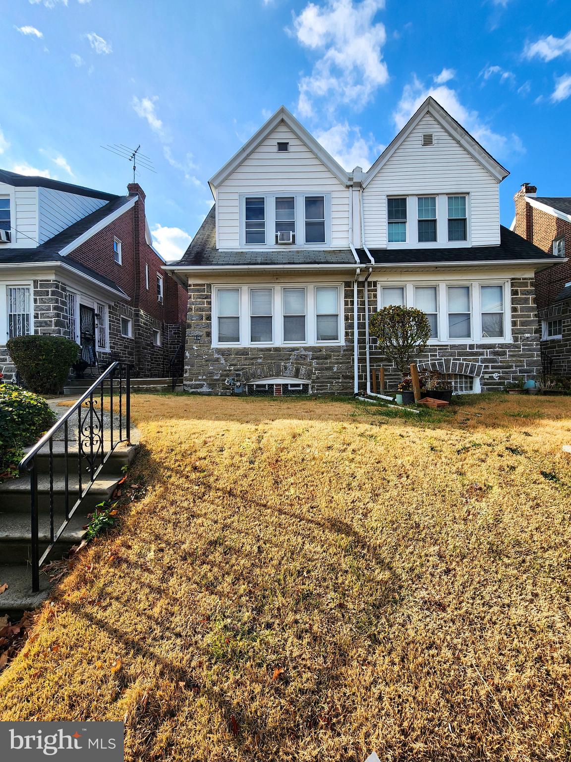 a front view of a house with yard and garage