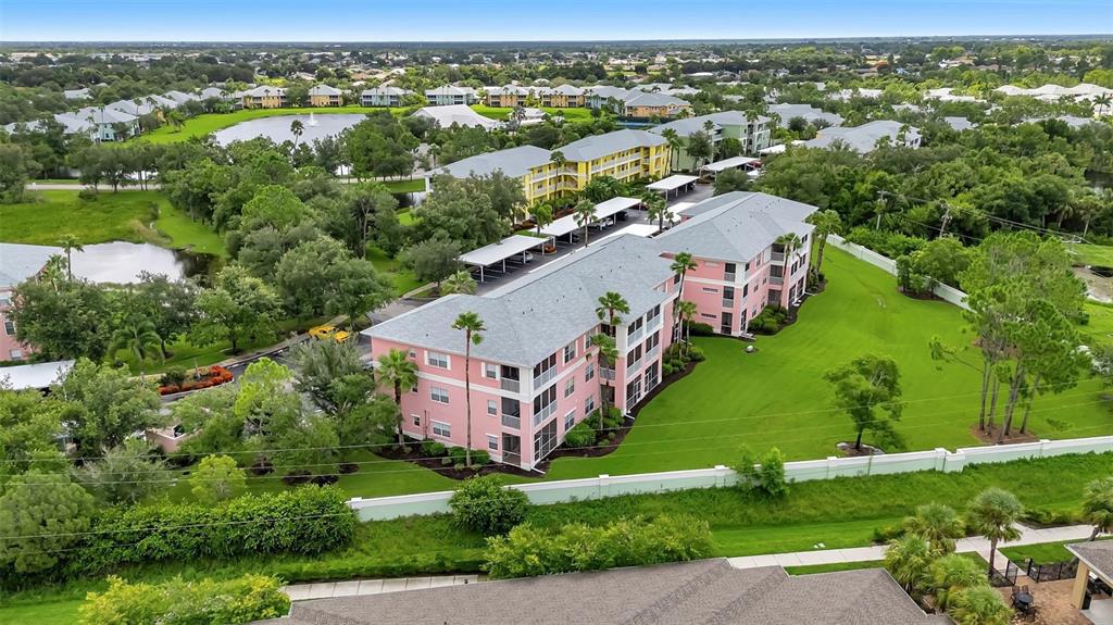 an aerial view of residential houses with outdoor space and river