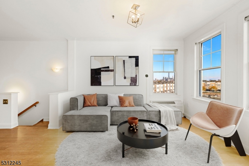 a living room with furniture a rug and a window