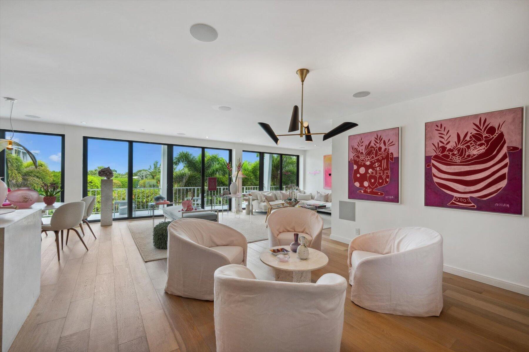 a living room with furniture and a floor to ceiling window