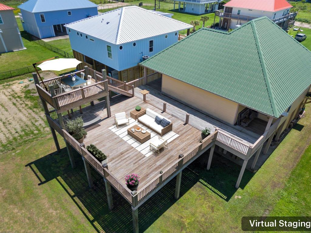 an aerial view of a house with pool table and chairs