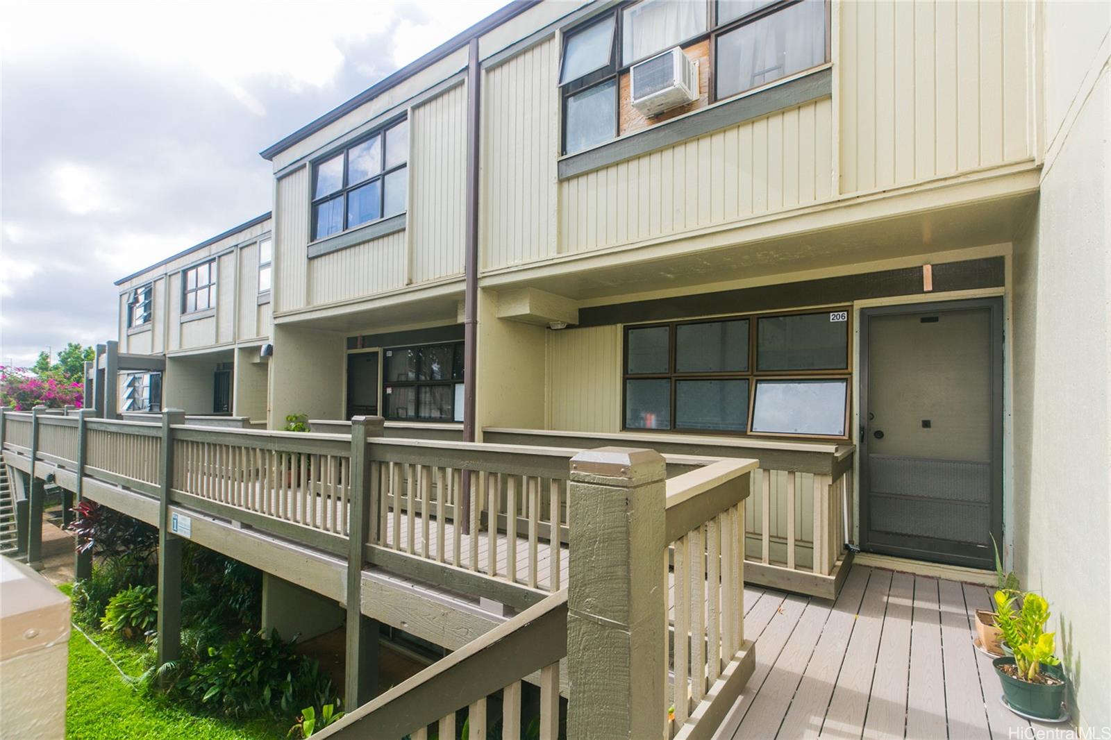 a view of a house with wooden deck