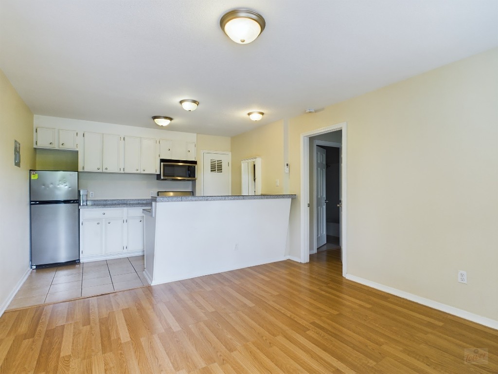 a kitchen with stainless steel appliances granite countertop a refrigerator sink and cabinets