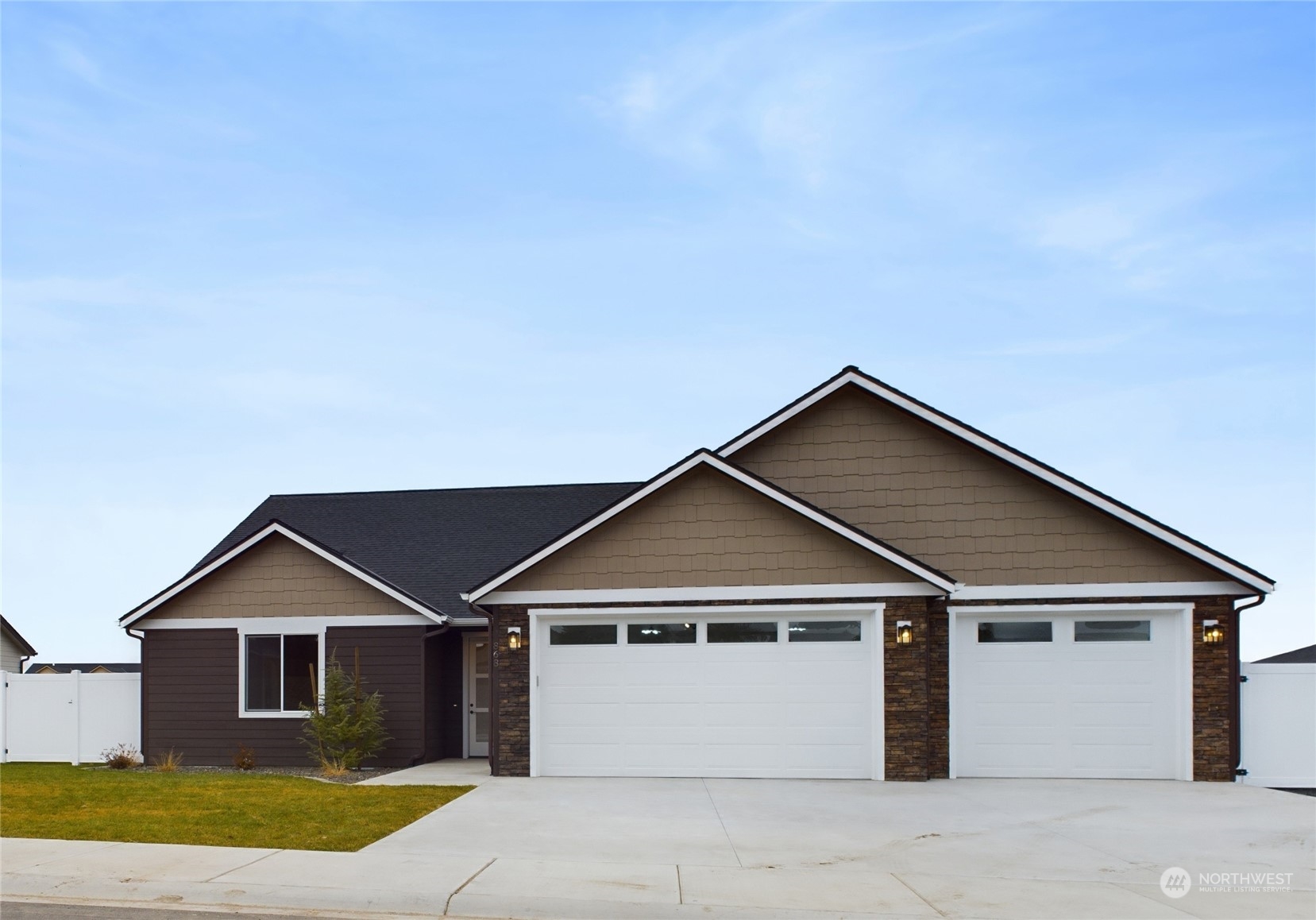 a front view of a house with a yard and garage