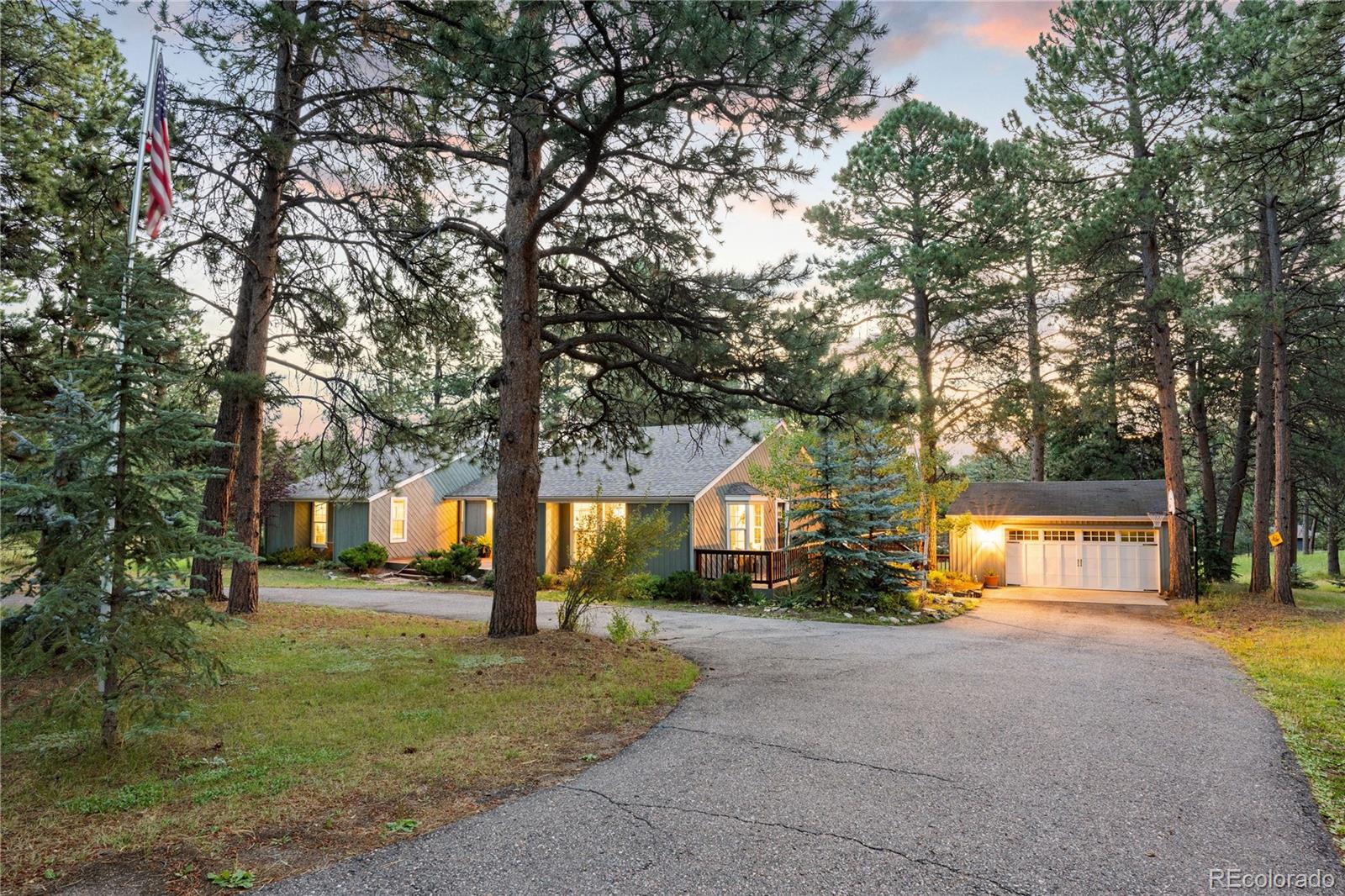 a front view of a house with a yard and tree s