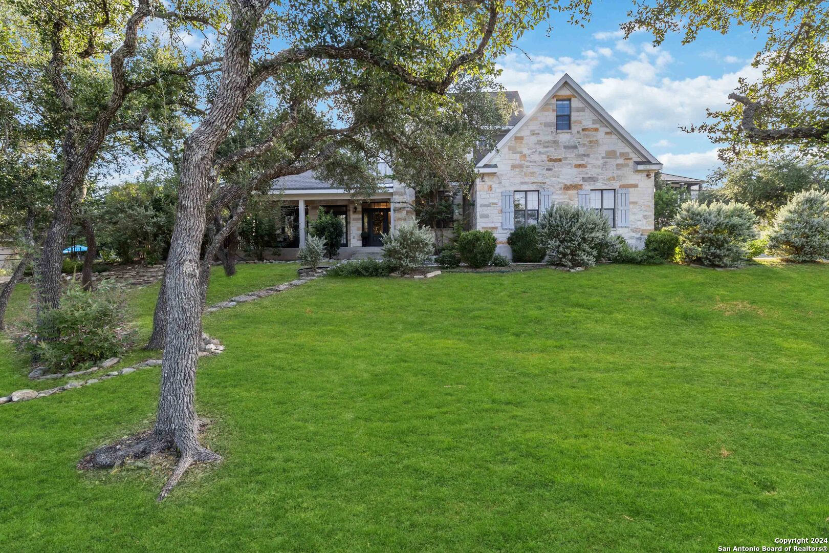 a front view of a house with a garden