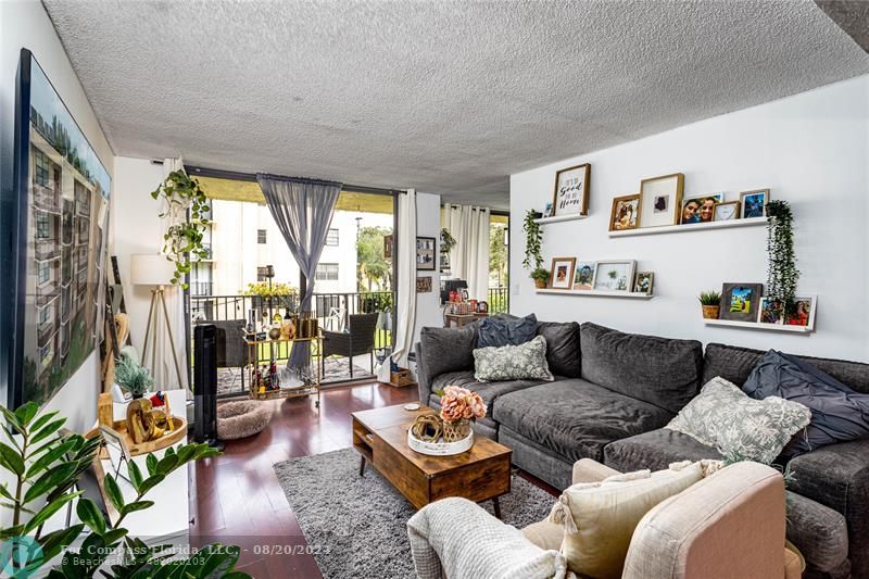 a living room with furniture and a floor to ceiling window