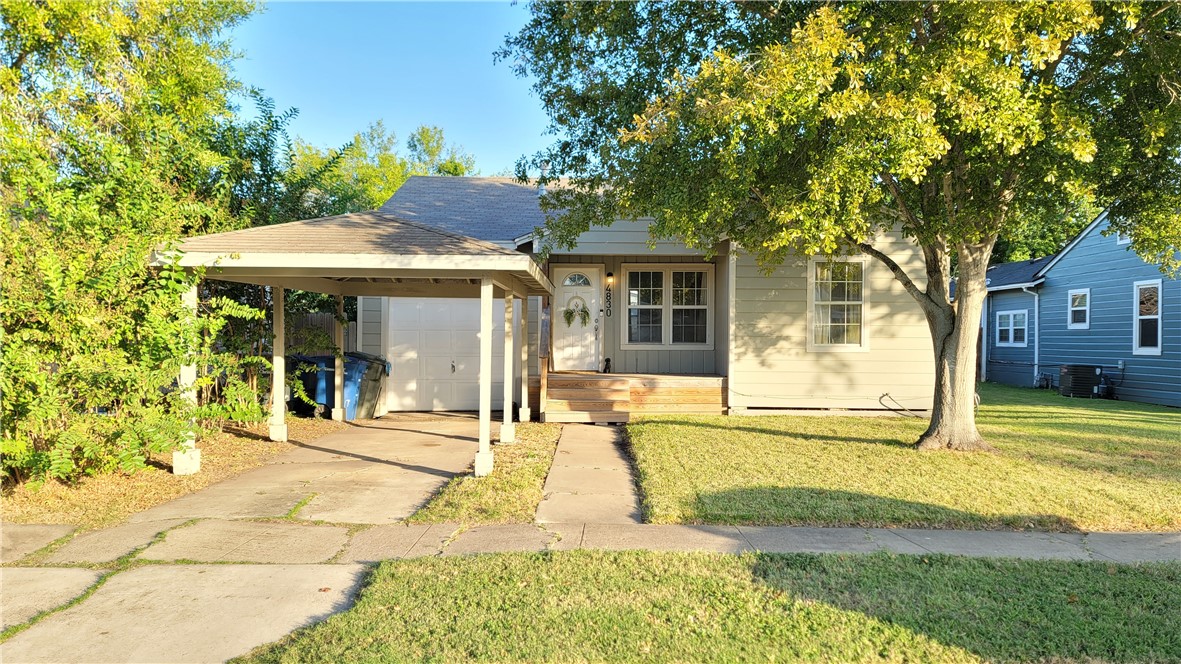 a view of a house with a backyard and a tree