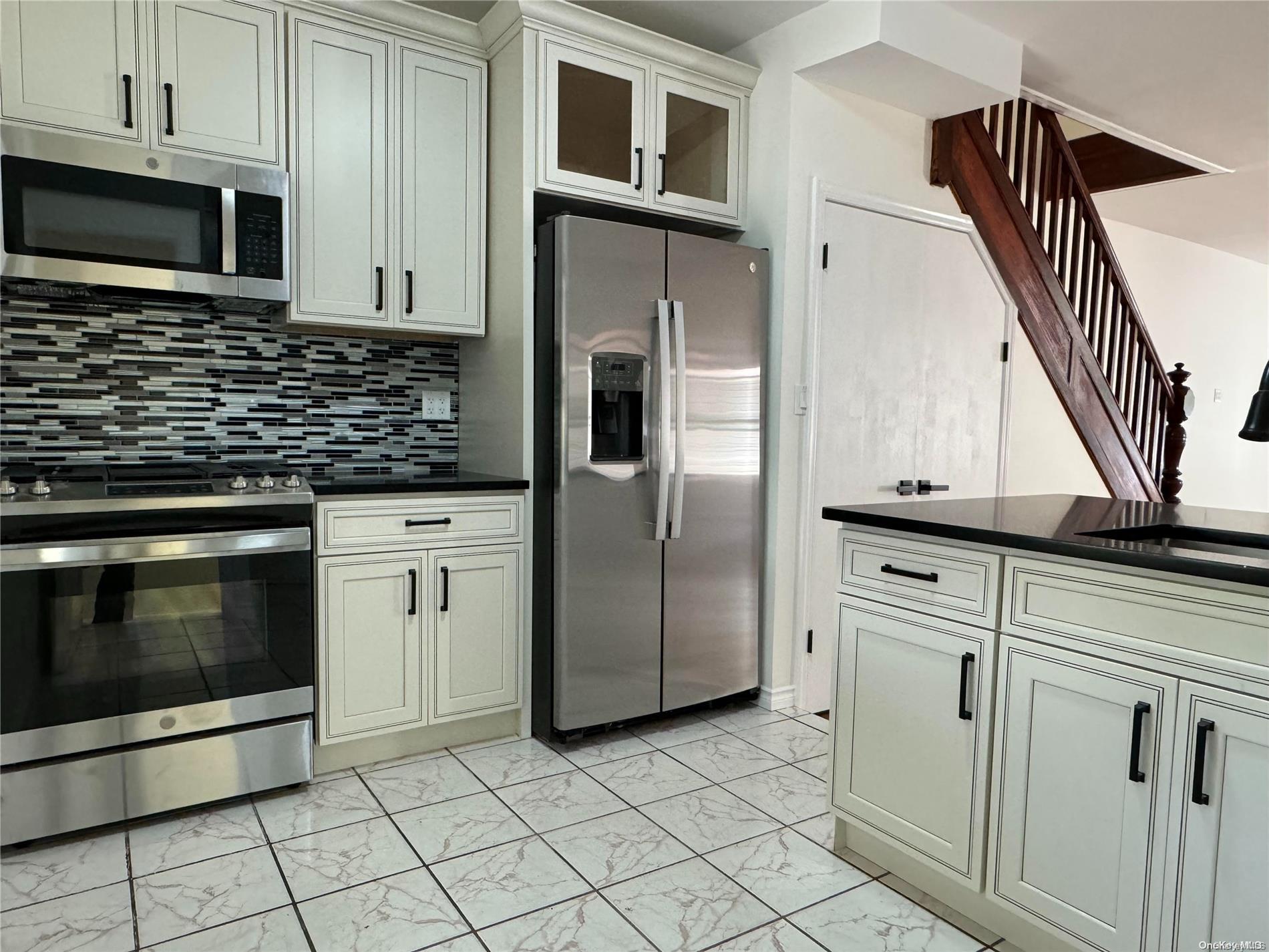 a kitchen with cabinets and stainless steel appliances