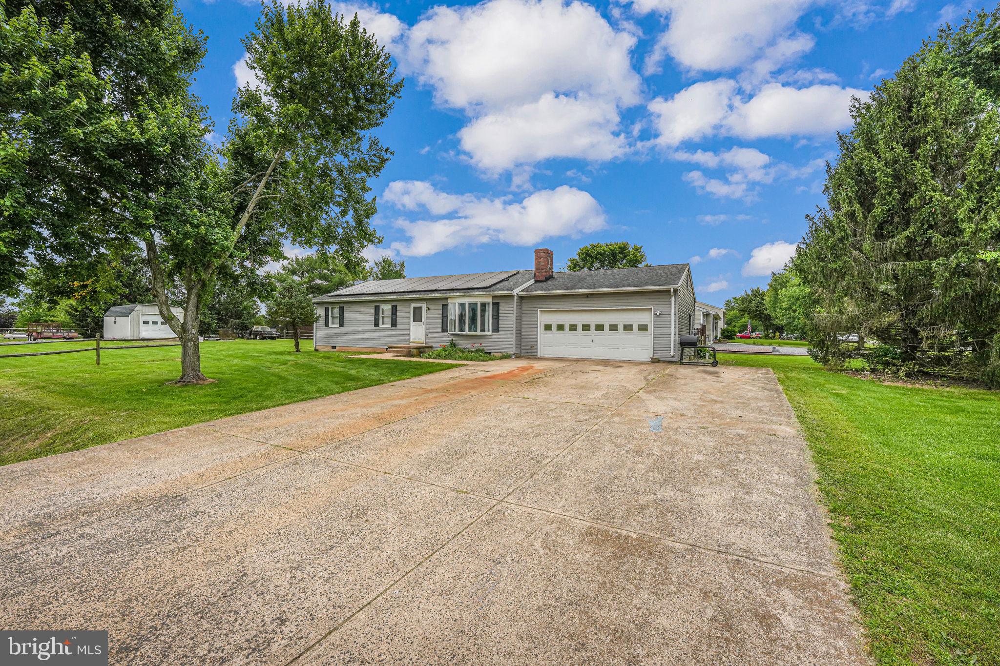 a view of house with yard and green space