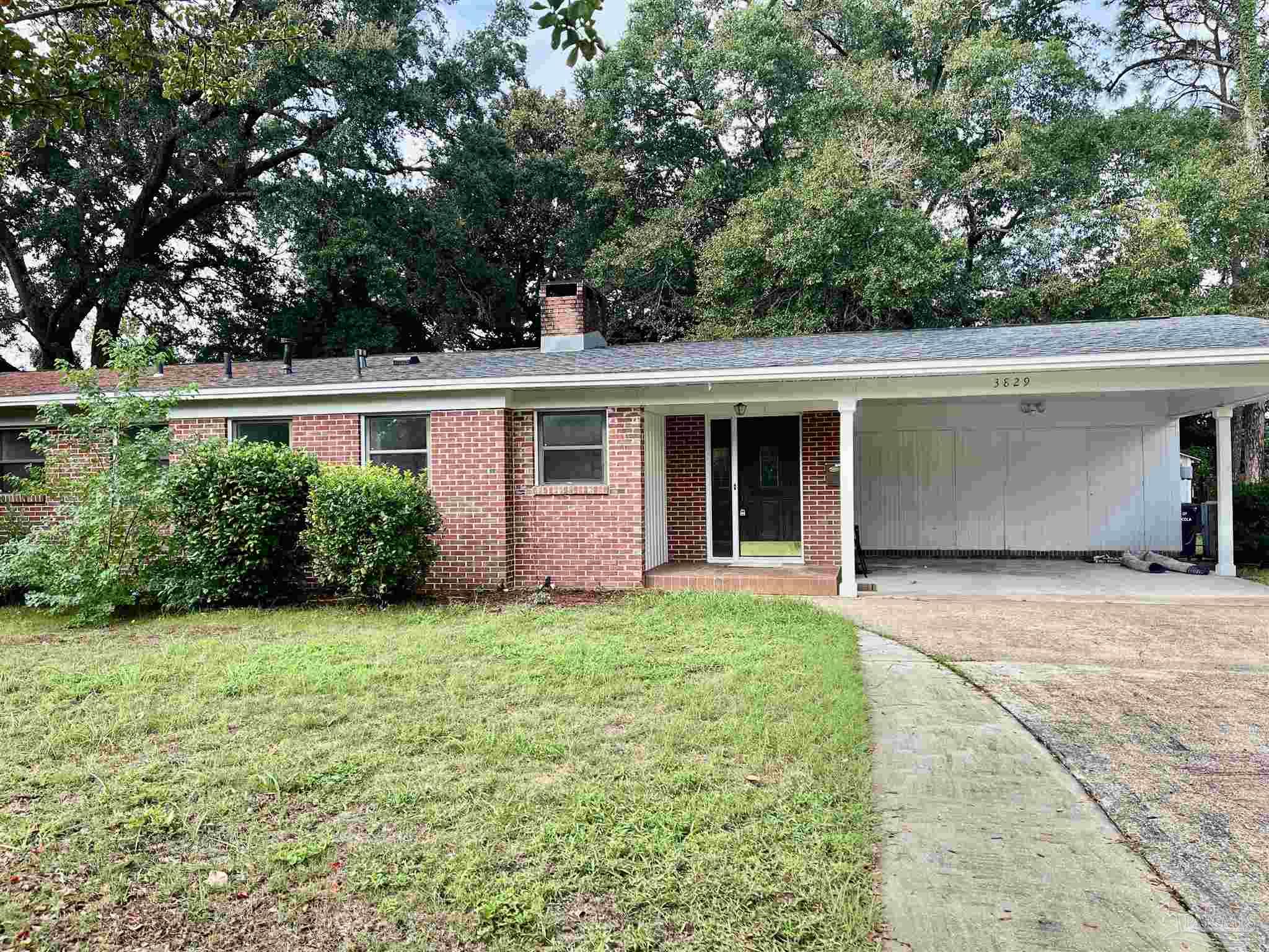 a front view of a house with a garden and yard