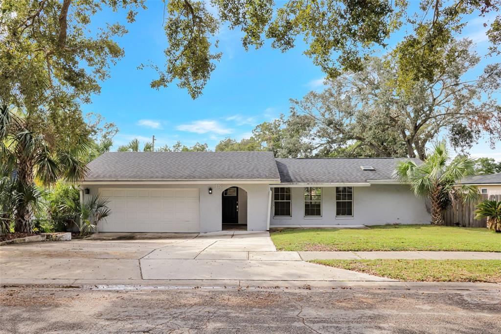 a house that has a tree in front of it