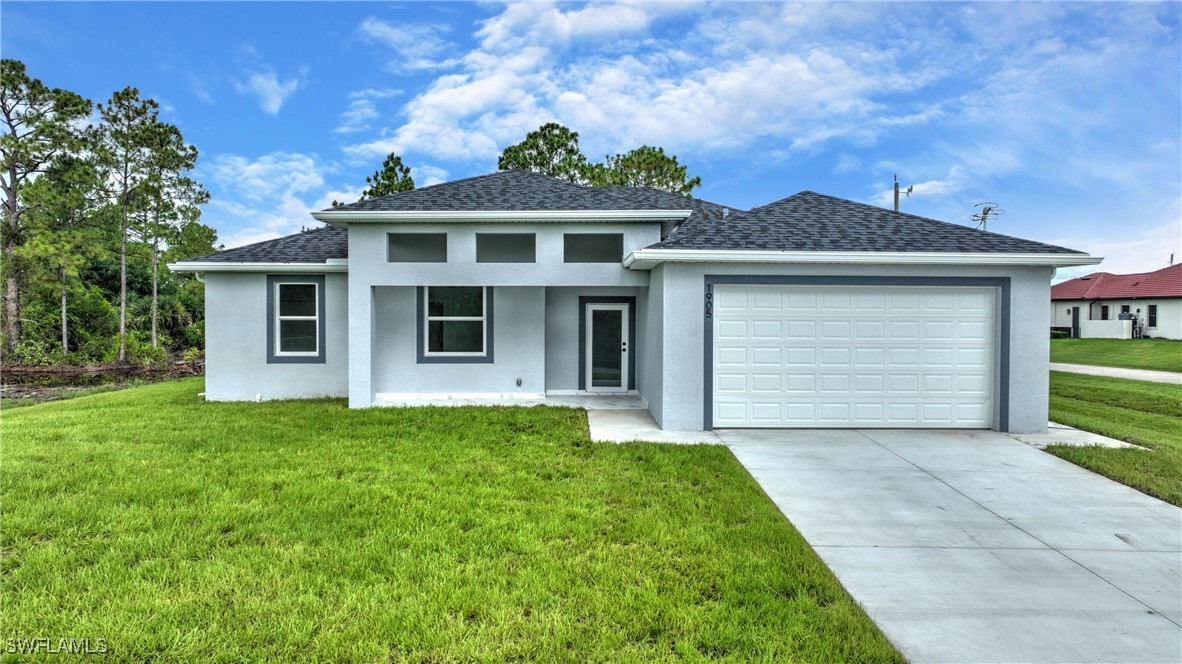 a front view of a house with a garden