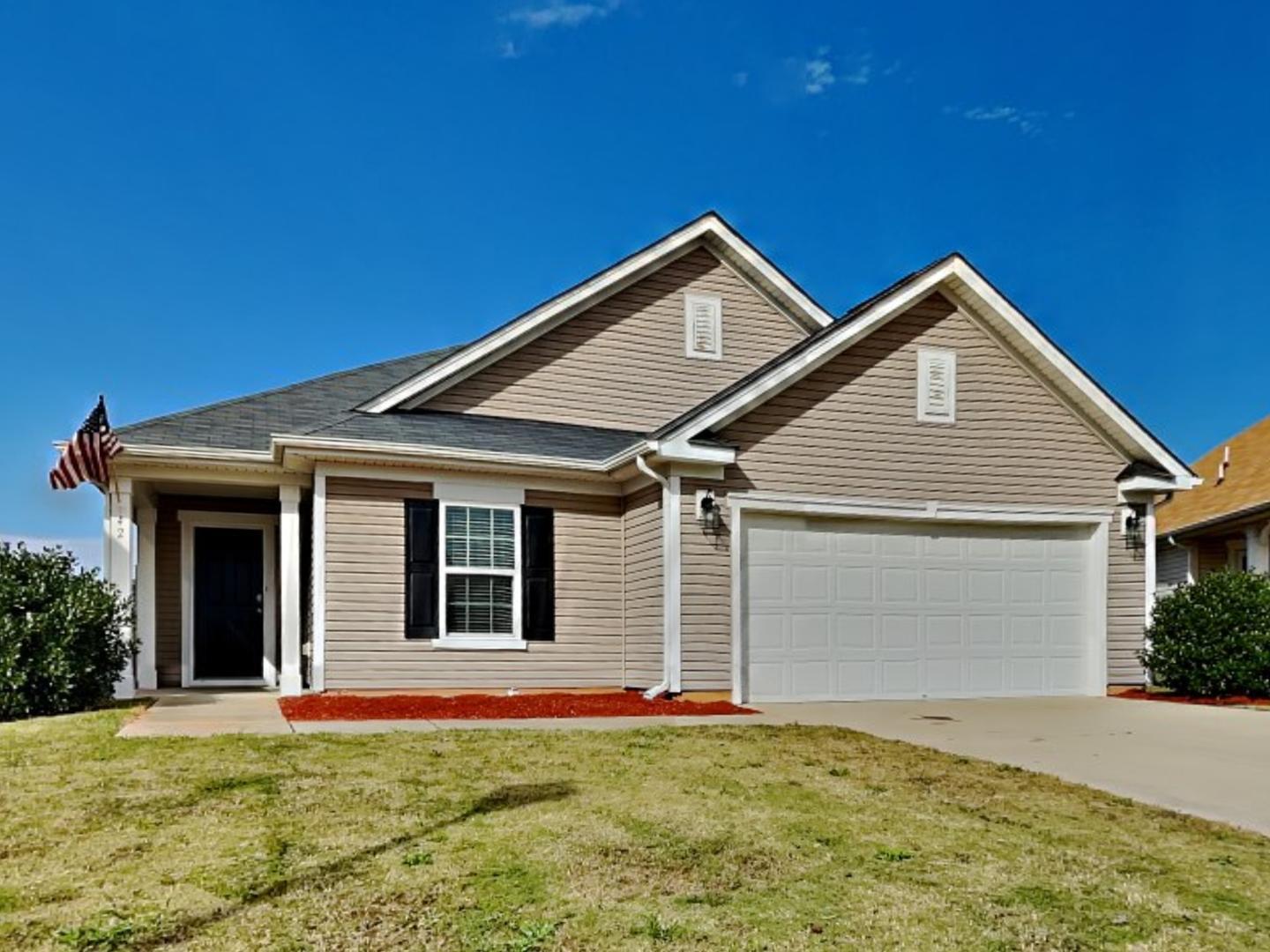 a front view of a house with a yard