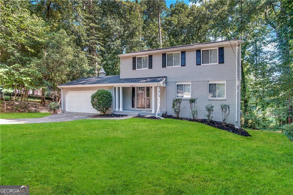 a view of a house with a backyard