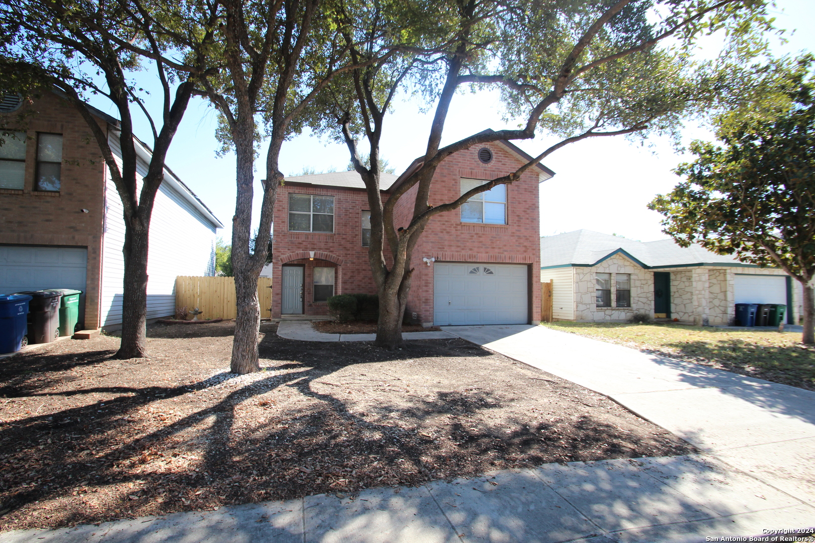 a house that has a tree in front of it