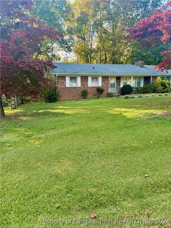 a front view of house with yard and green space