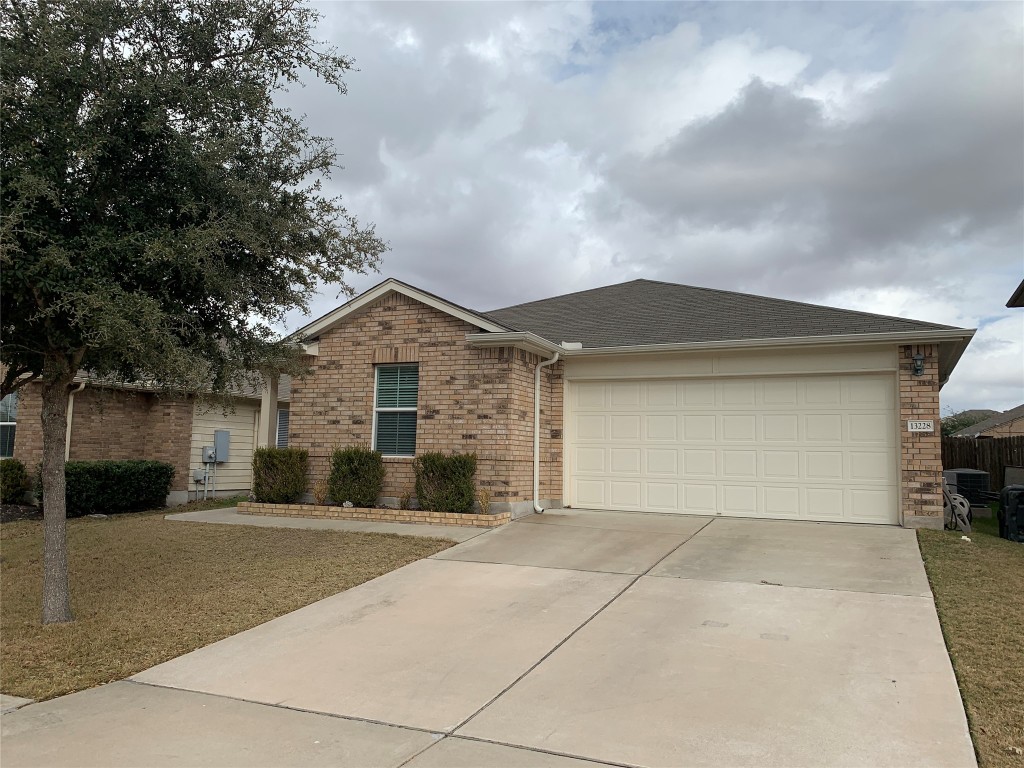 a view of a house with a yard and garage