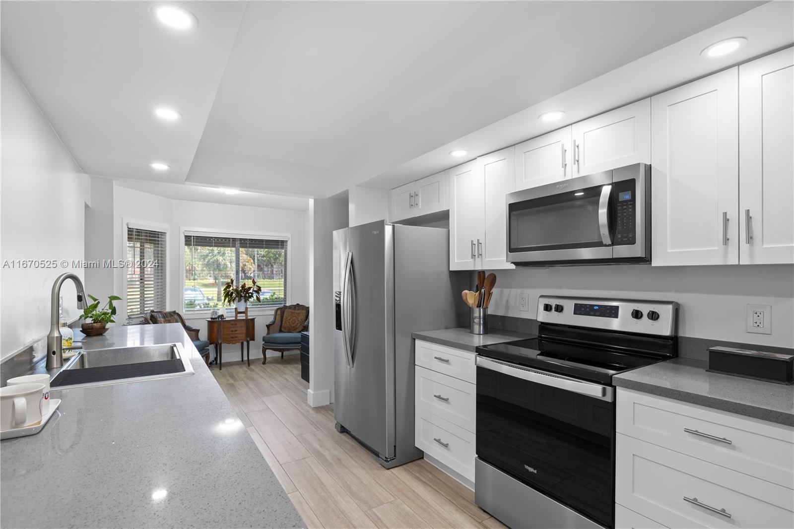 a kitchen with stainless steel appliances a stove microwave and refrigerator