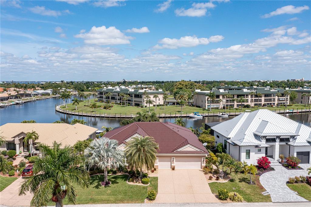 an aerial view of a house with a garden and lake view