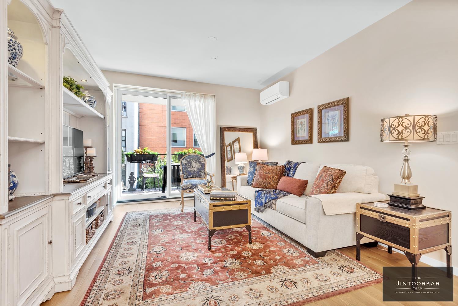 a living room with furniture a large window and a rug