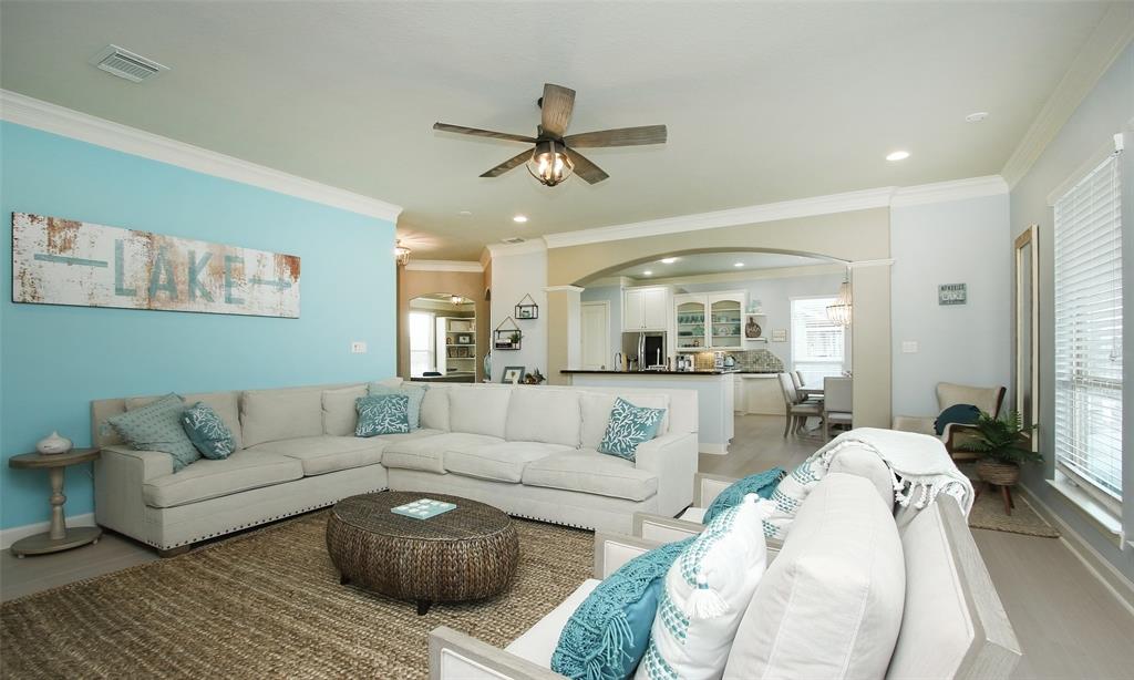 a living room with furniture and a ceiling fan