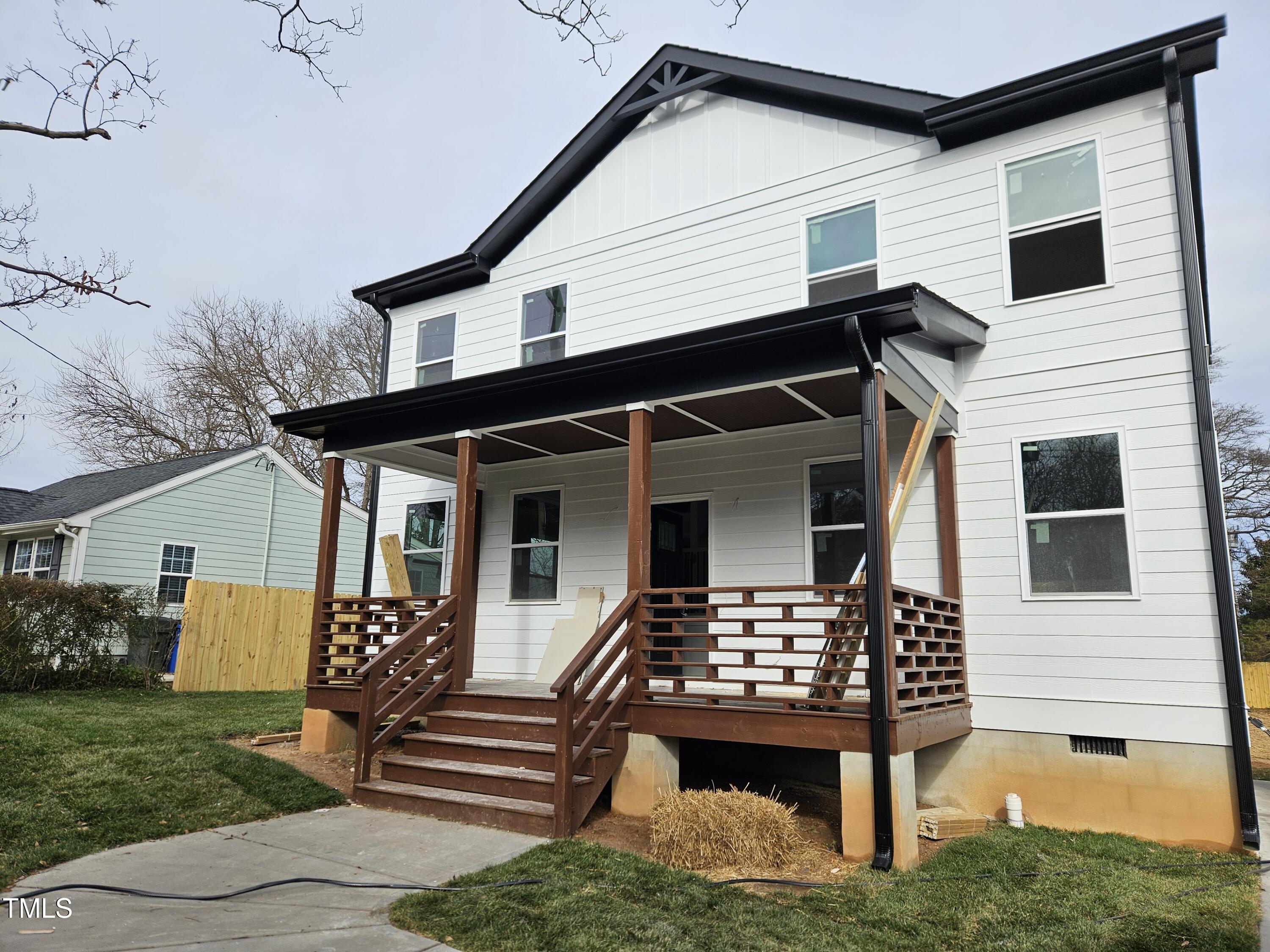 a view of house with backyard space and balcony