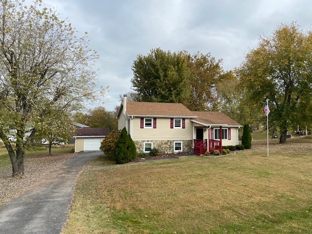 a view of a house with a yard and trees