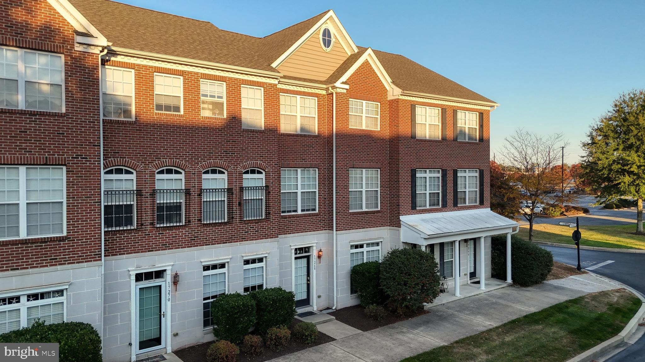 a front view of a residential apartment building with a yard