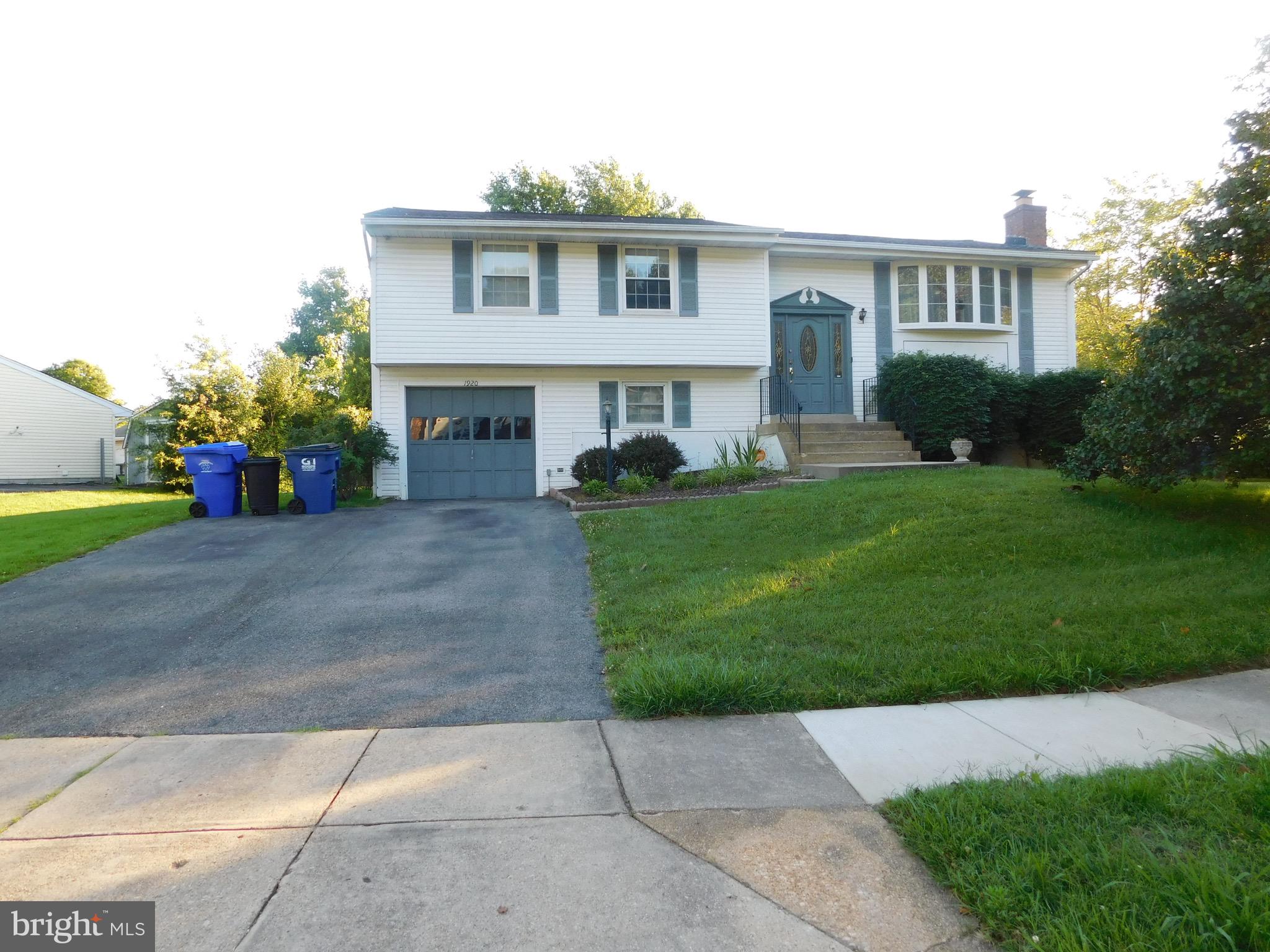 a front view of a house with a garden and garage