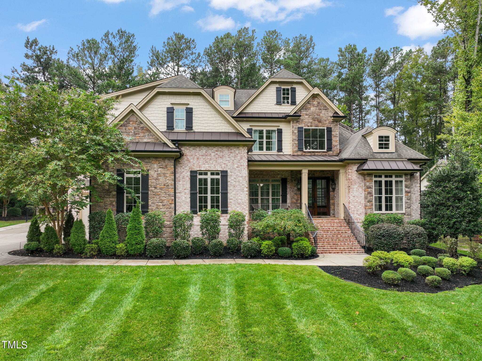 a front view of a house with a garden