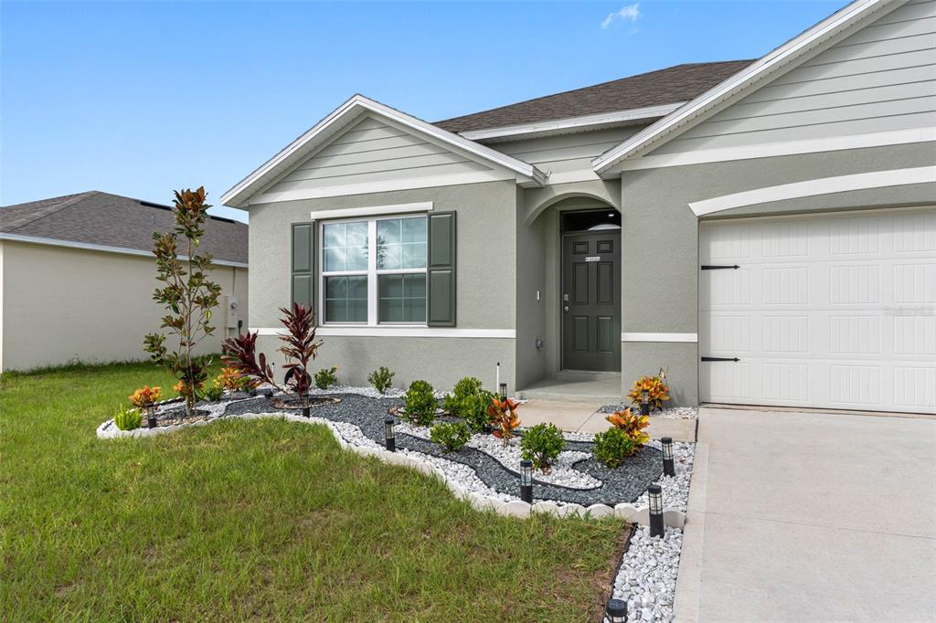 a front view of a house with garden