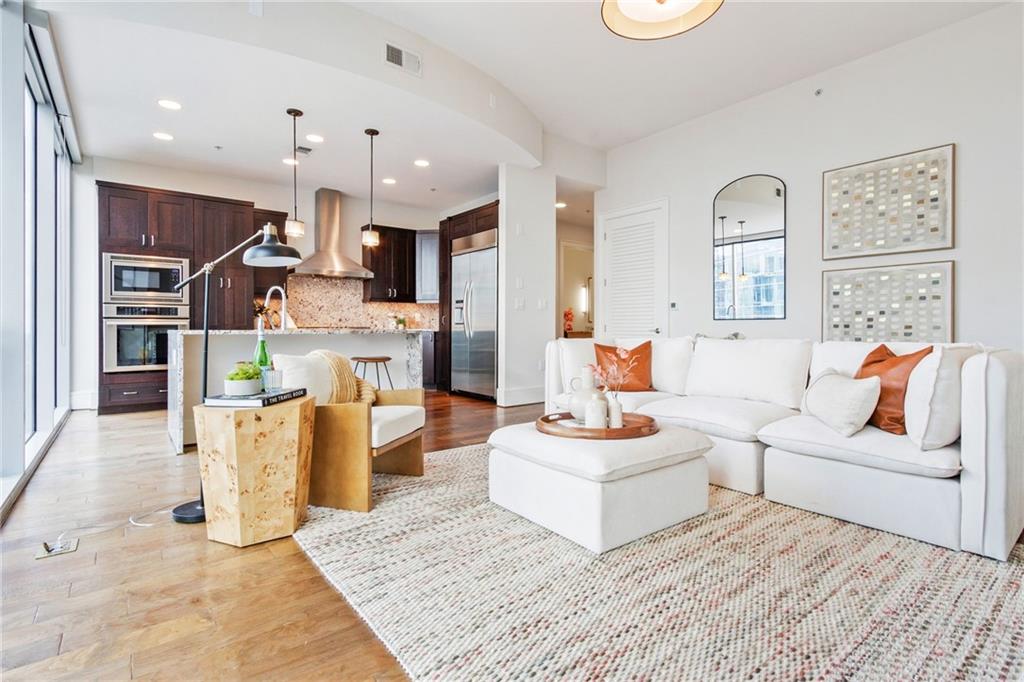 a living room with fireplace furniture and a rug