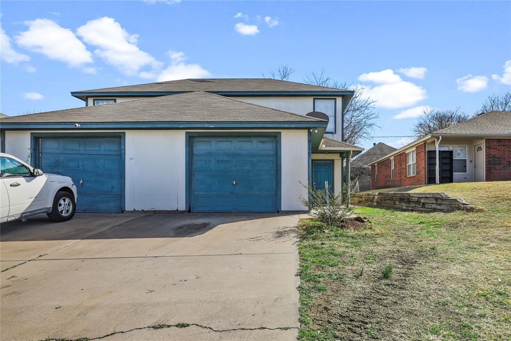 a blue house with yard in front of it