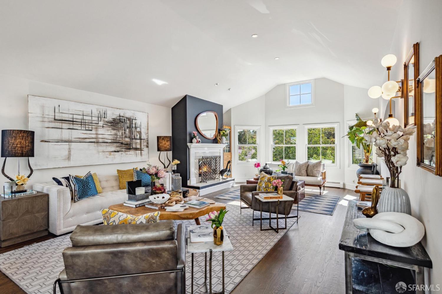 a living room with fireplace furniture and a large window