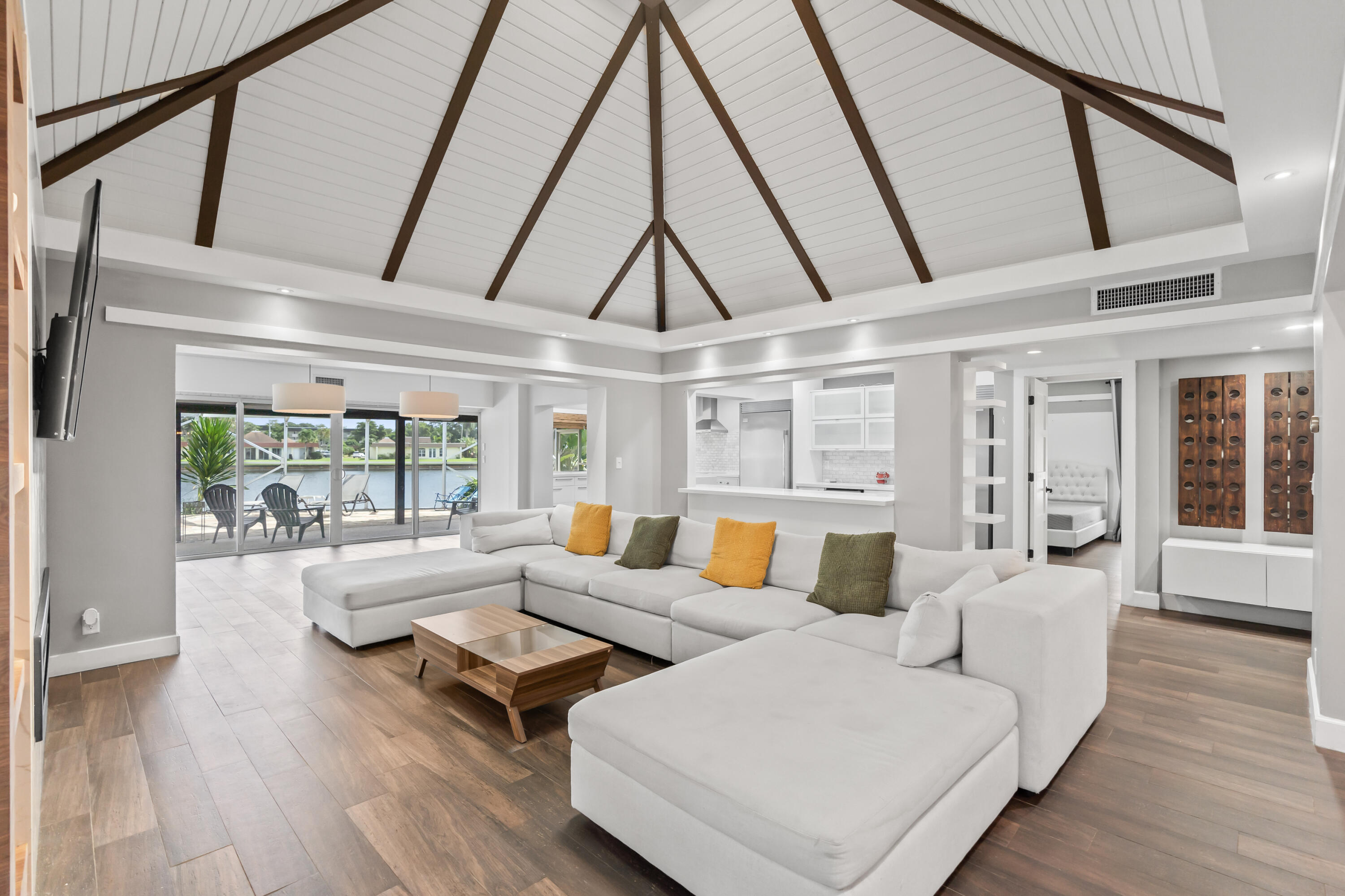 a living room with furniture and floor to ceiling windows