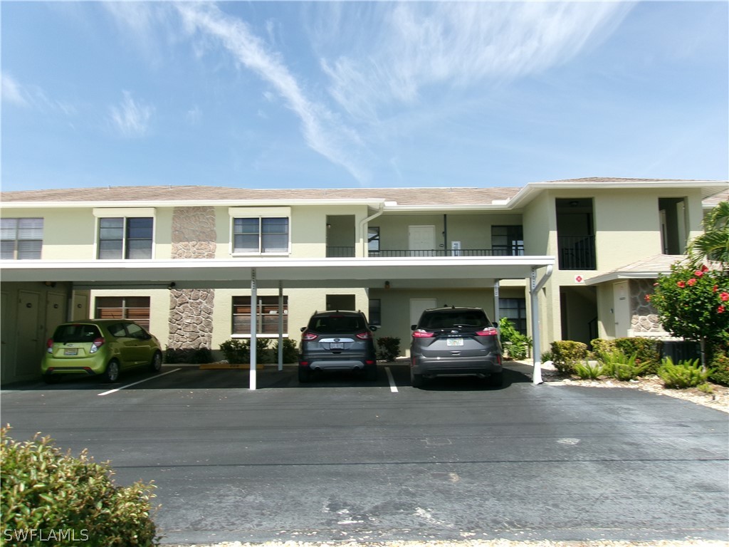 a front view of a house with car parked