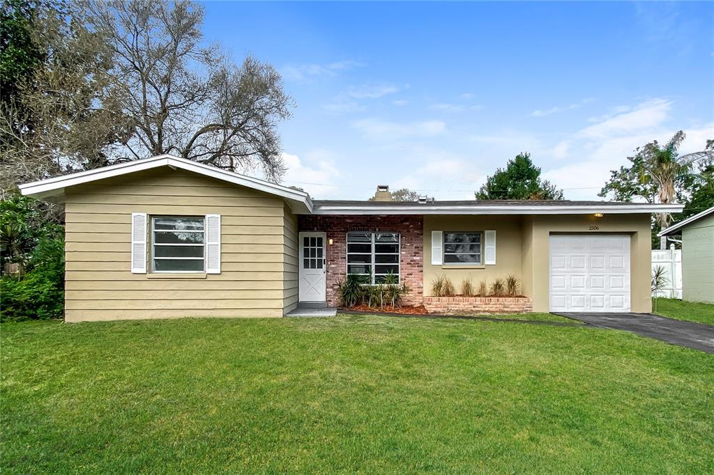 a front view of house with yard and green space