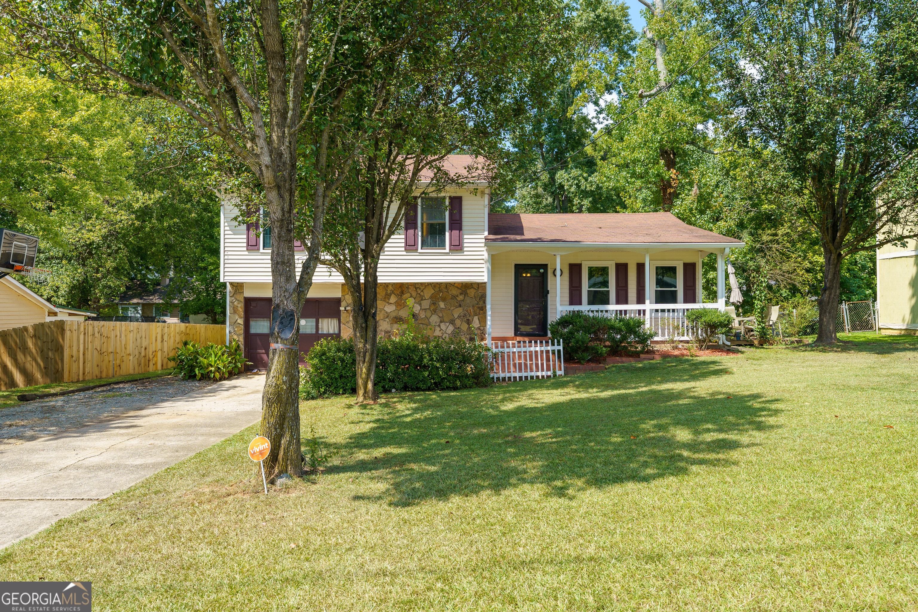 a front view of a house with a yard table and chairs