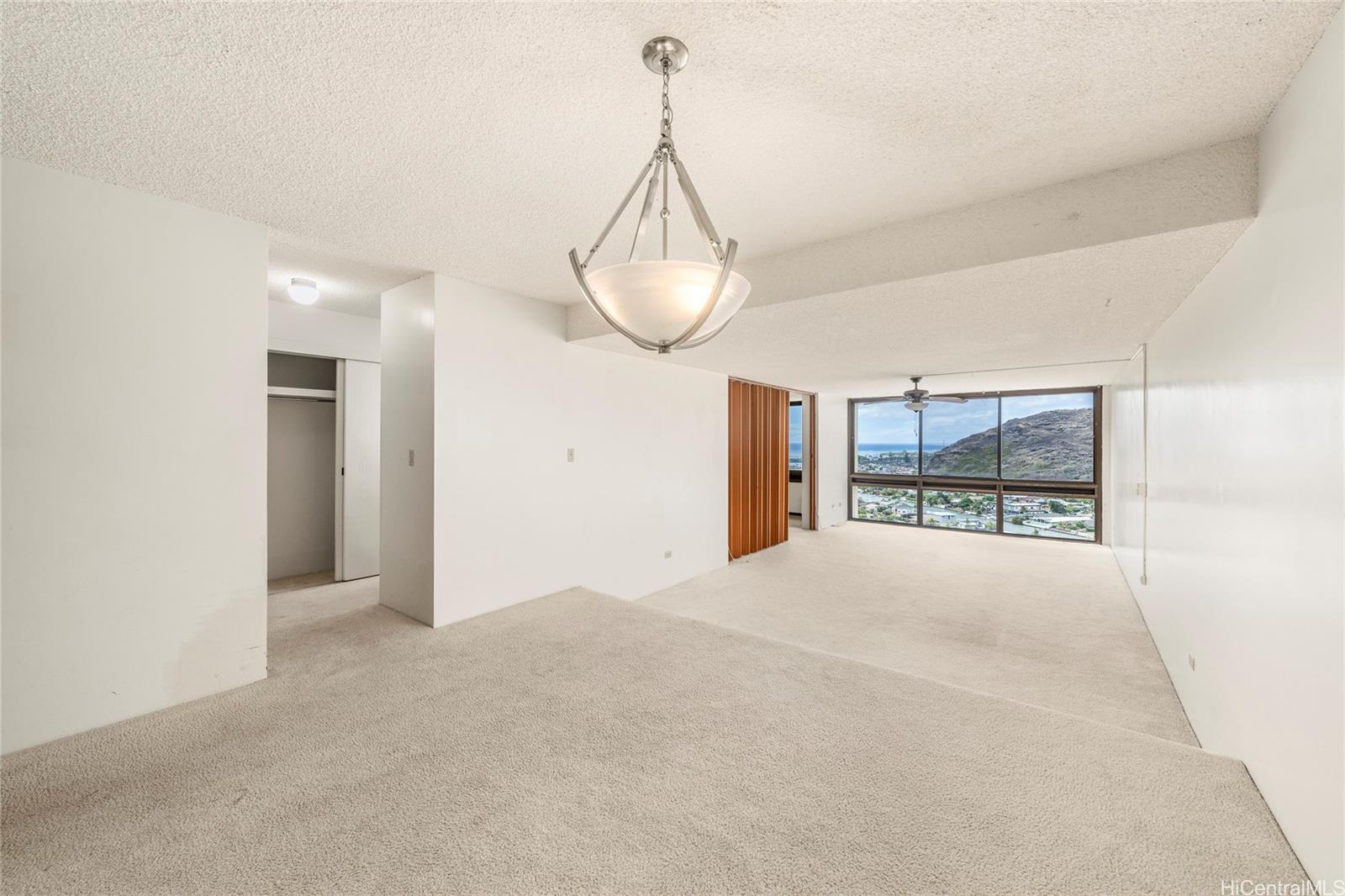 a view of a room with window and wooden floor