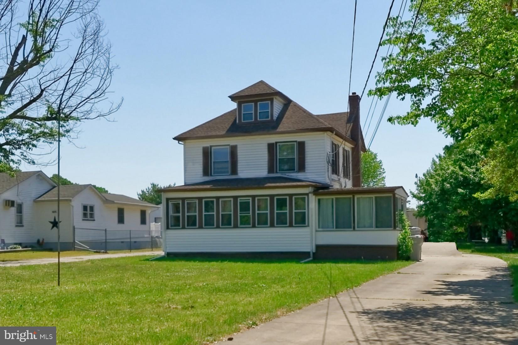 a view of a house with a yard and a garden