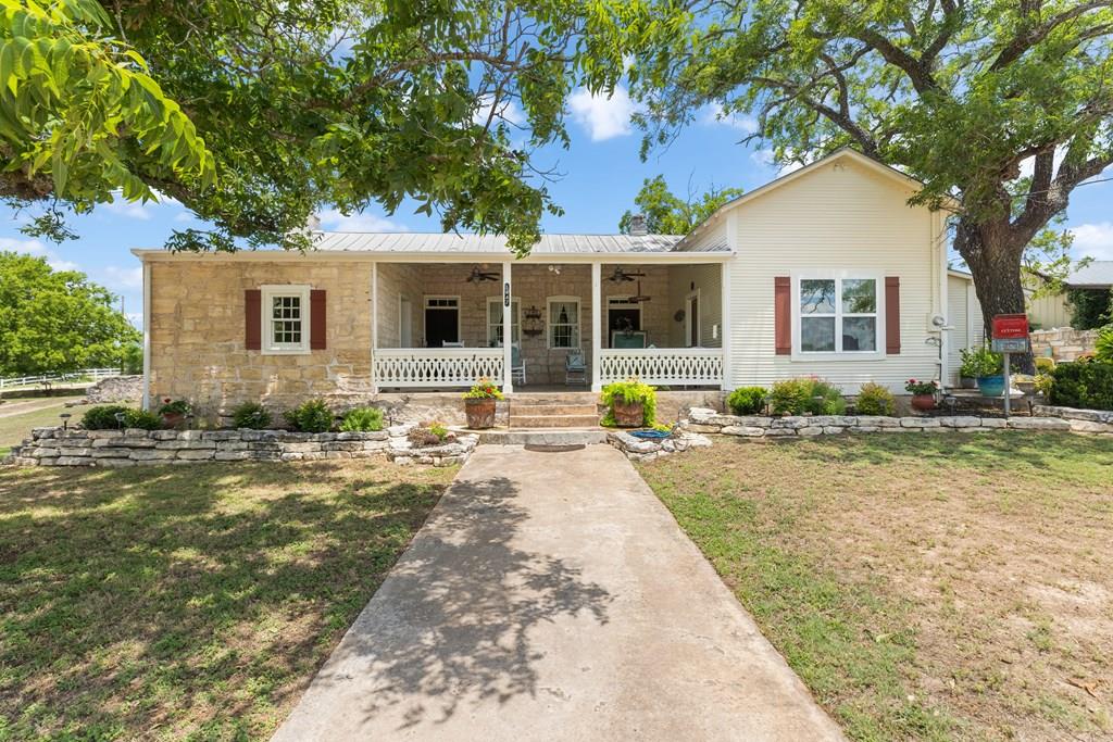 a front view of house with yard patio and green space