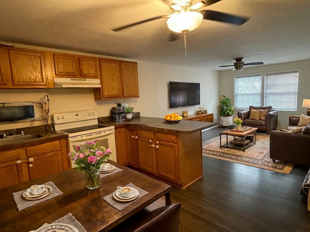 a kitchen with a refrigerator and a stove top oven