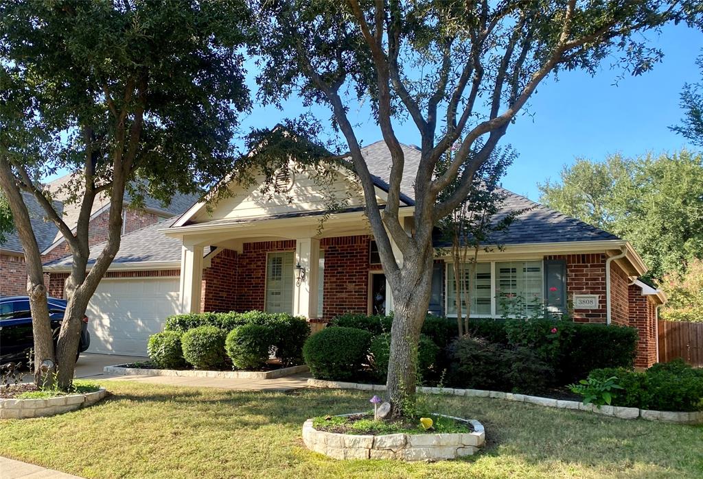 a front view of a house with a yard garage and outdoor seating