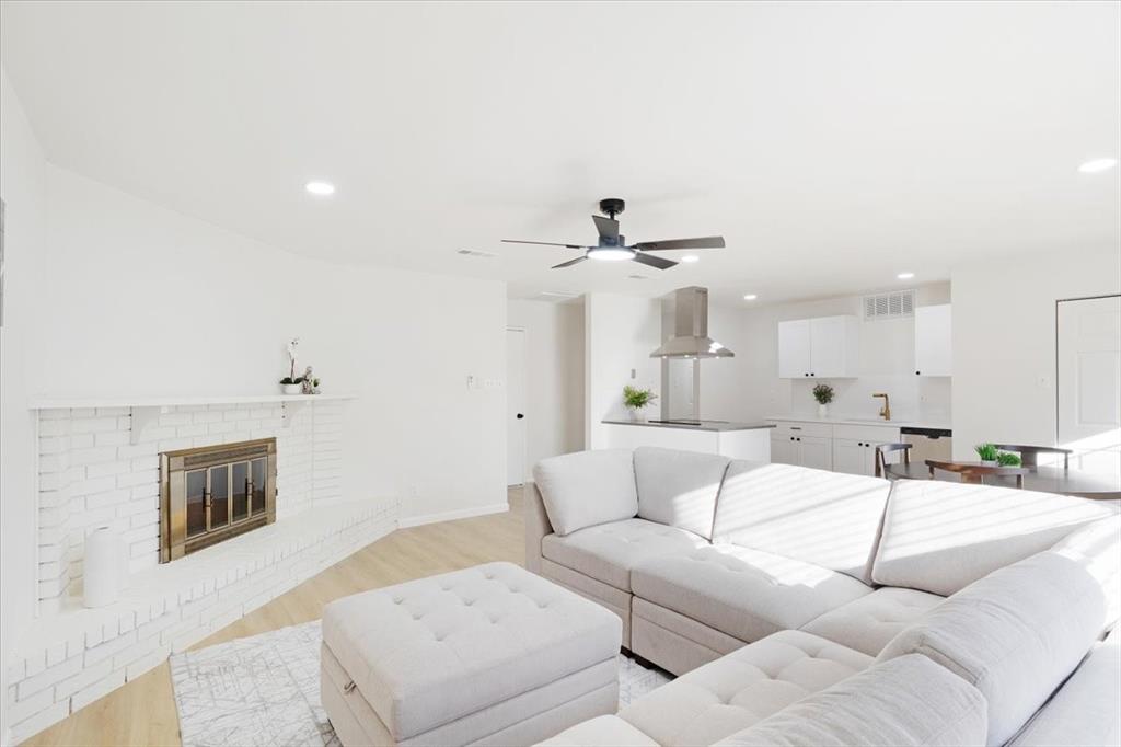 a living room with furniture and a ceiling fan